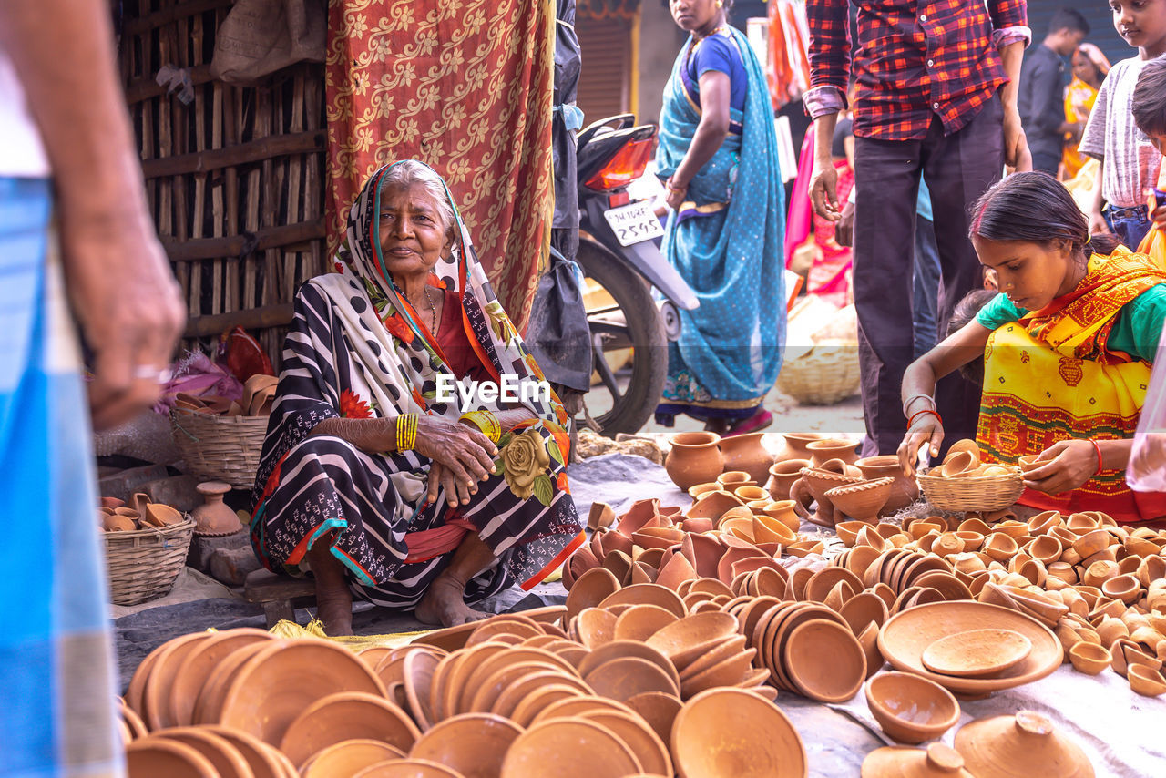 GROUP OF PEOPLE IN MARKET STALL