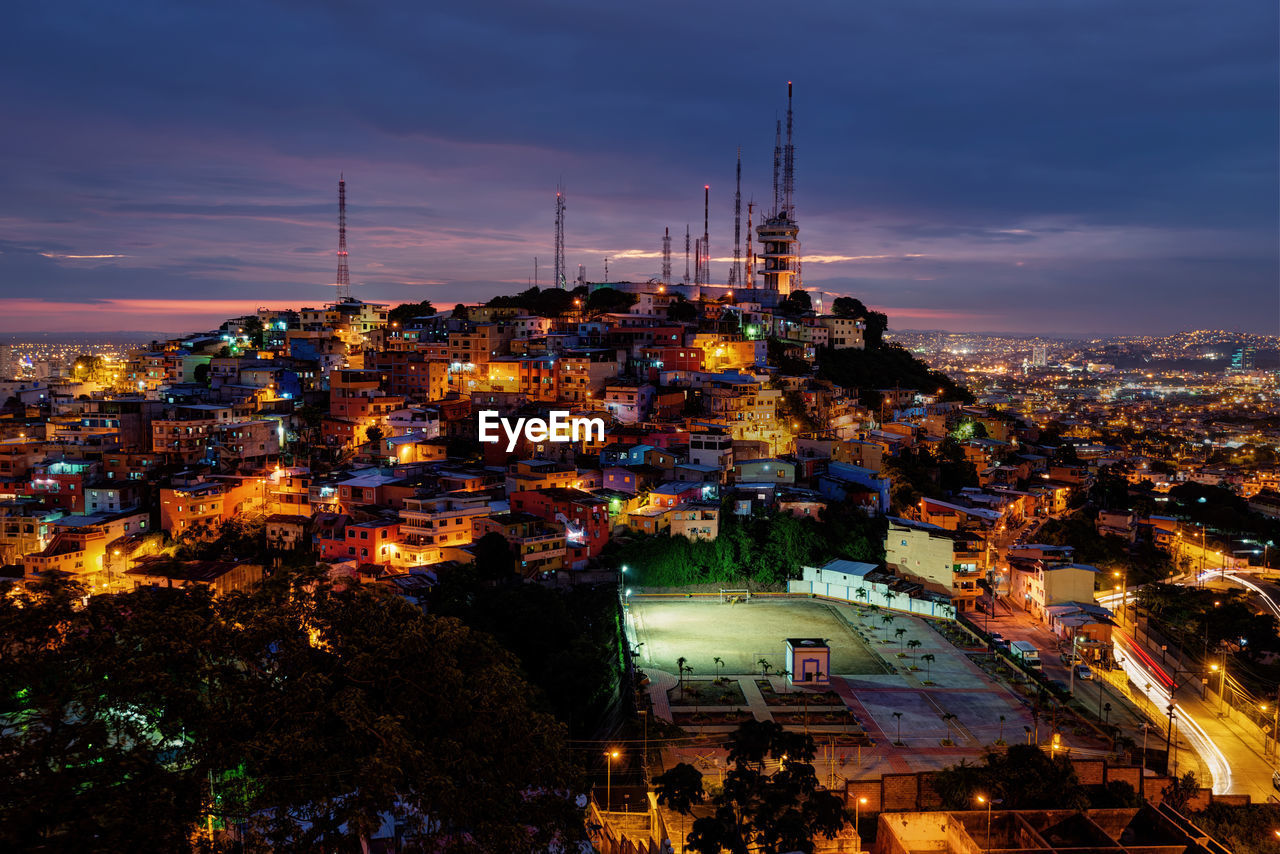 High angle view of illuminated buildings in city at night