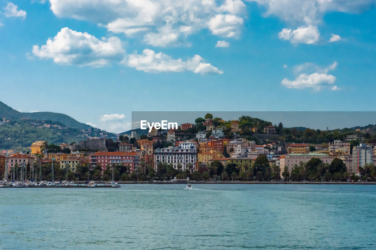 Scenic view of sea and cityscape against sky