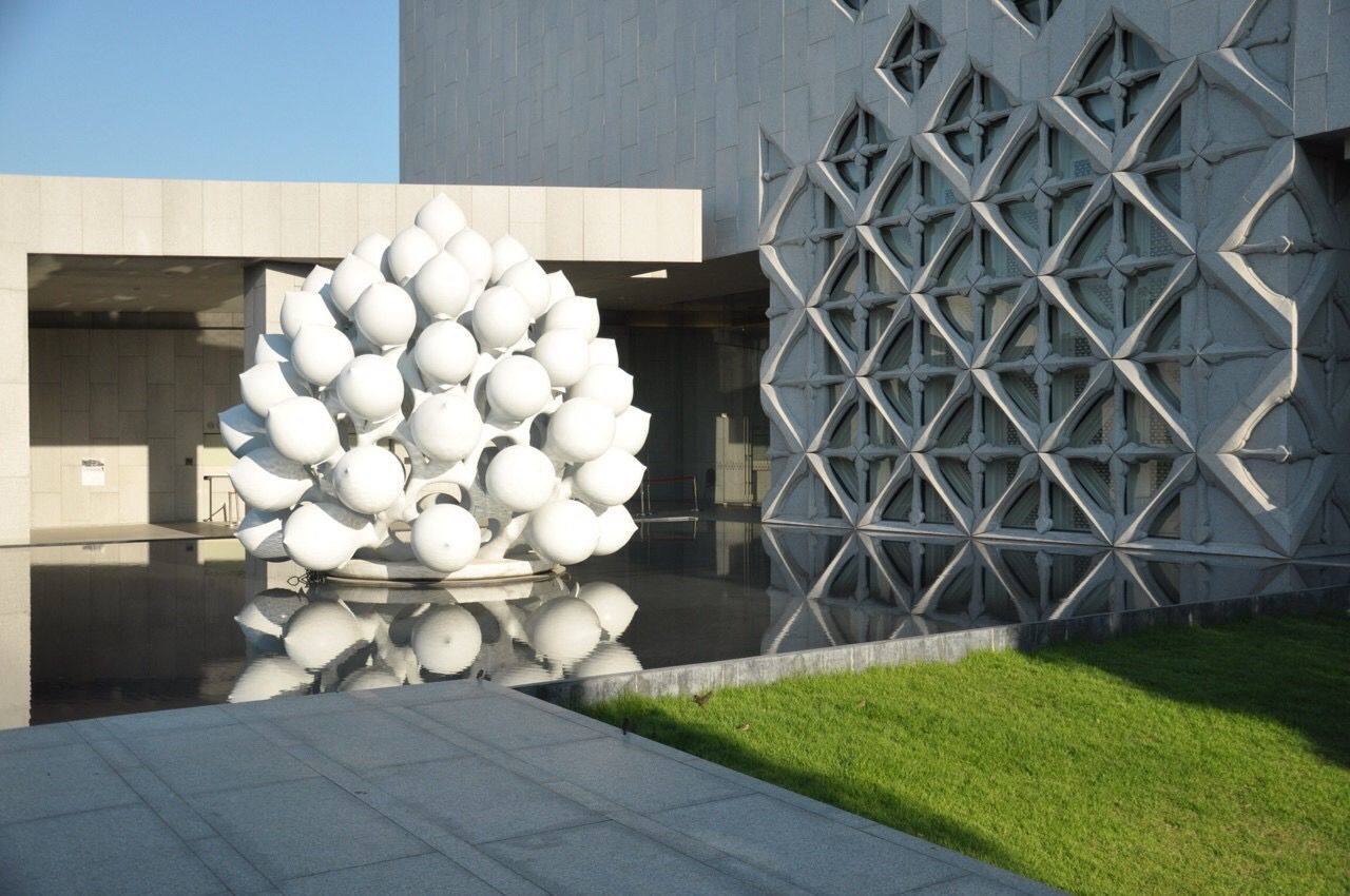 Modern architectural design of water fountain on building lawn 