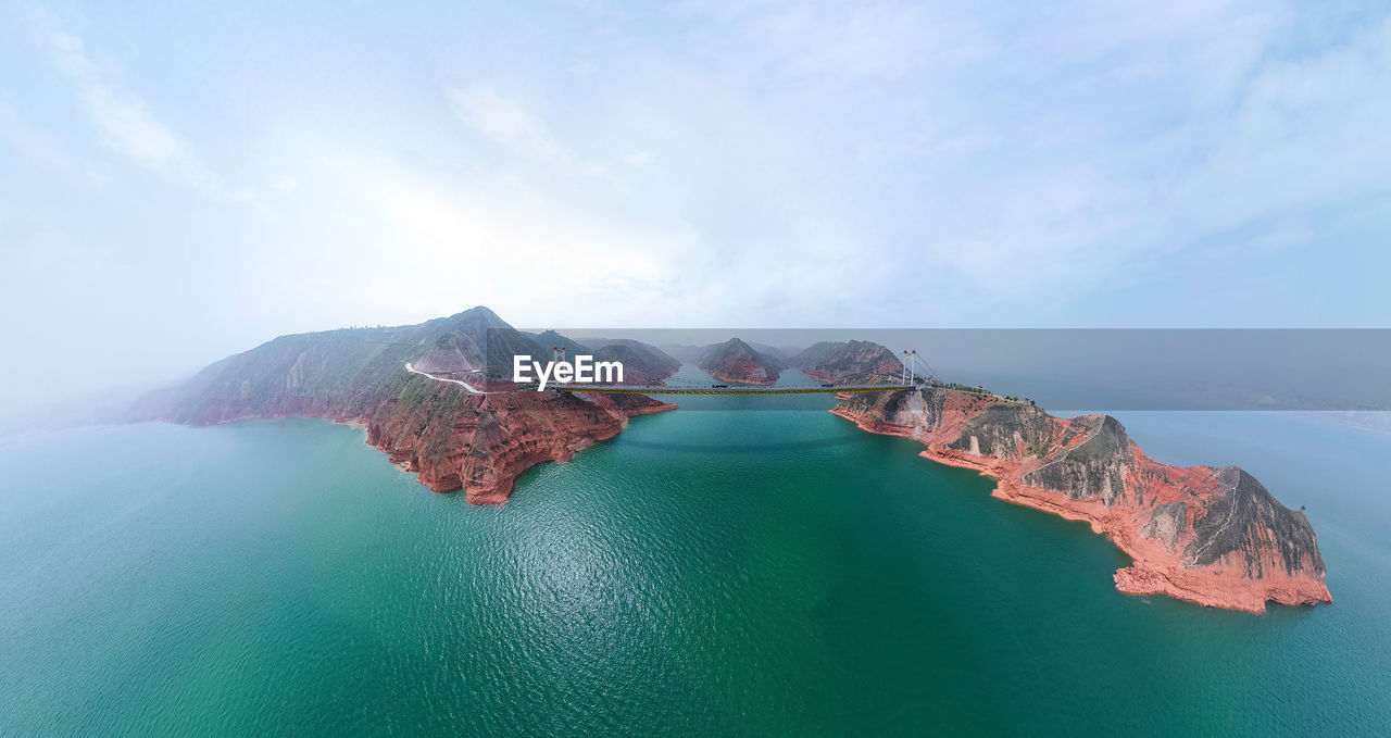 Aerial view of bridge over sea against sky