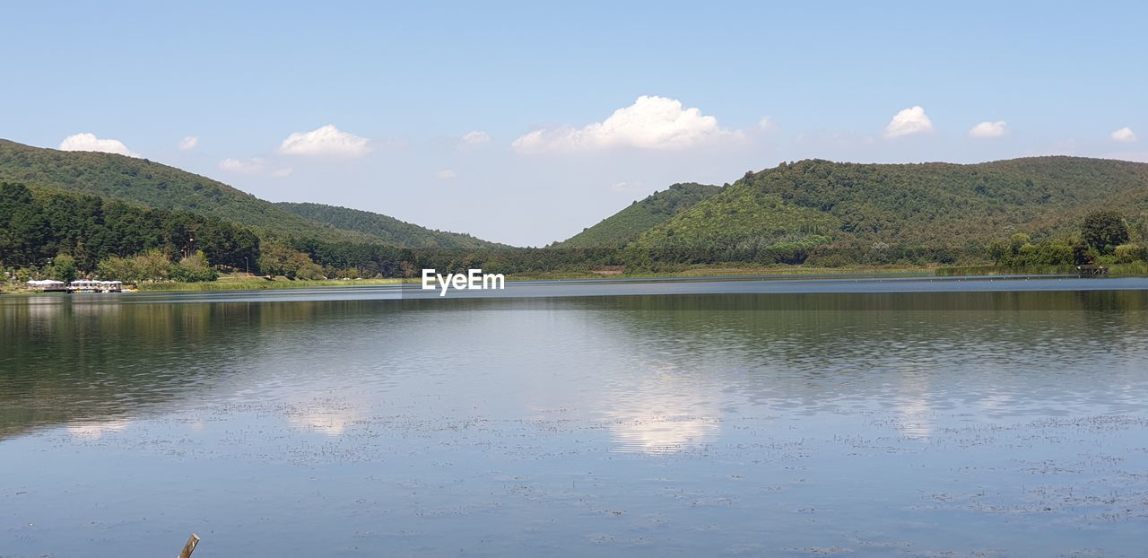 Scenic view of lake and mountains against sky