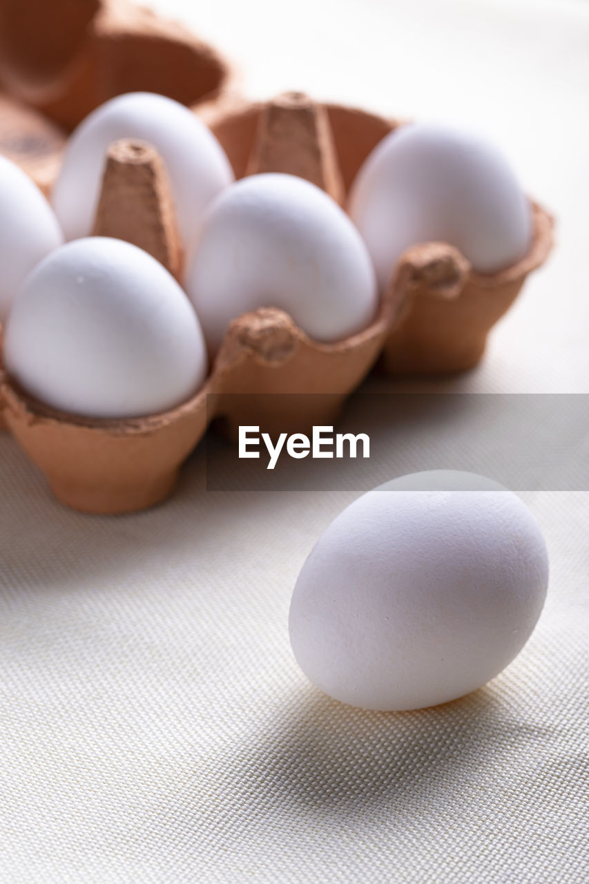 HIGH ANGLE VIEW OF EGGS IN CONTAINER