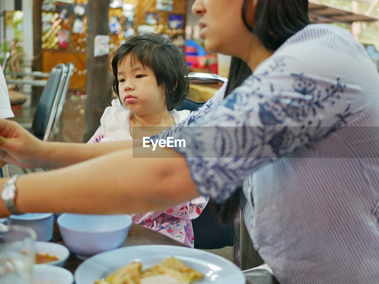 Mother and daughter at restaurant