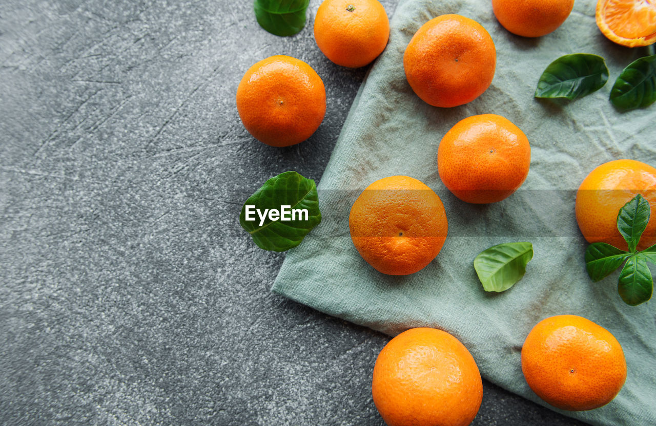 Fresh citrus fruits tangerines, oranges on a concrete background