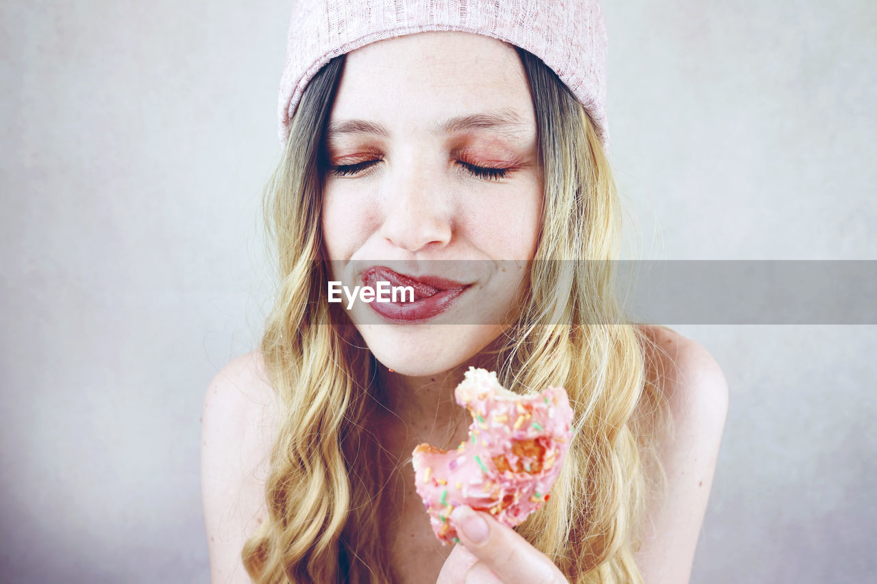 Close-up of woman having donut