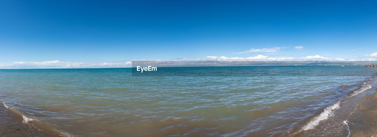 SCENIC VIEW OF BEACH AGAINST BLUE SKY