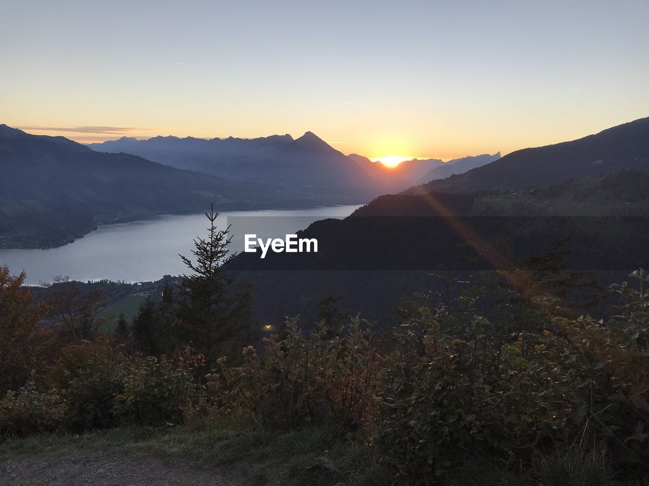 SCENIC VIEW OF MOUNTAINS AGAINST SKY AT SUNSET