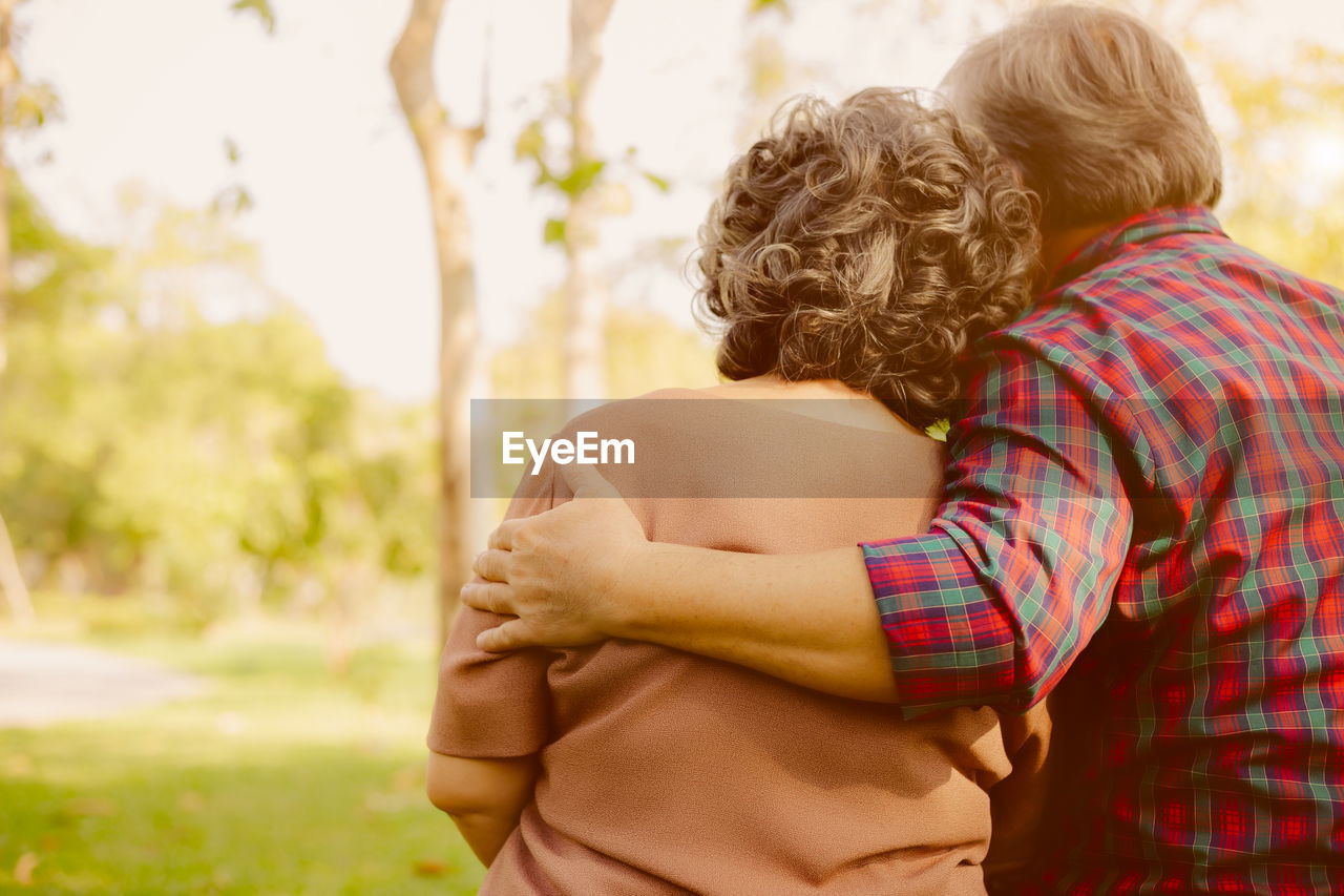 Rear view of senior couple sitting at park