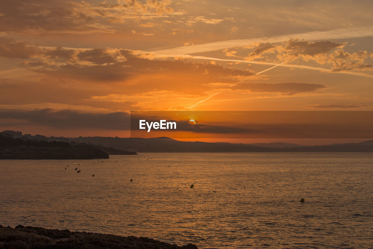 Scenic view of sea against sky during sunset