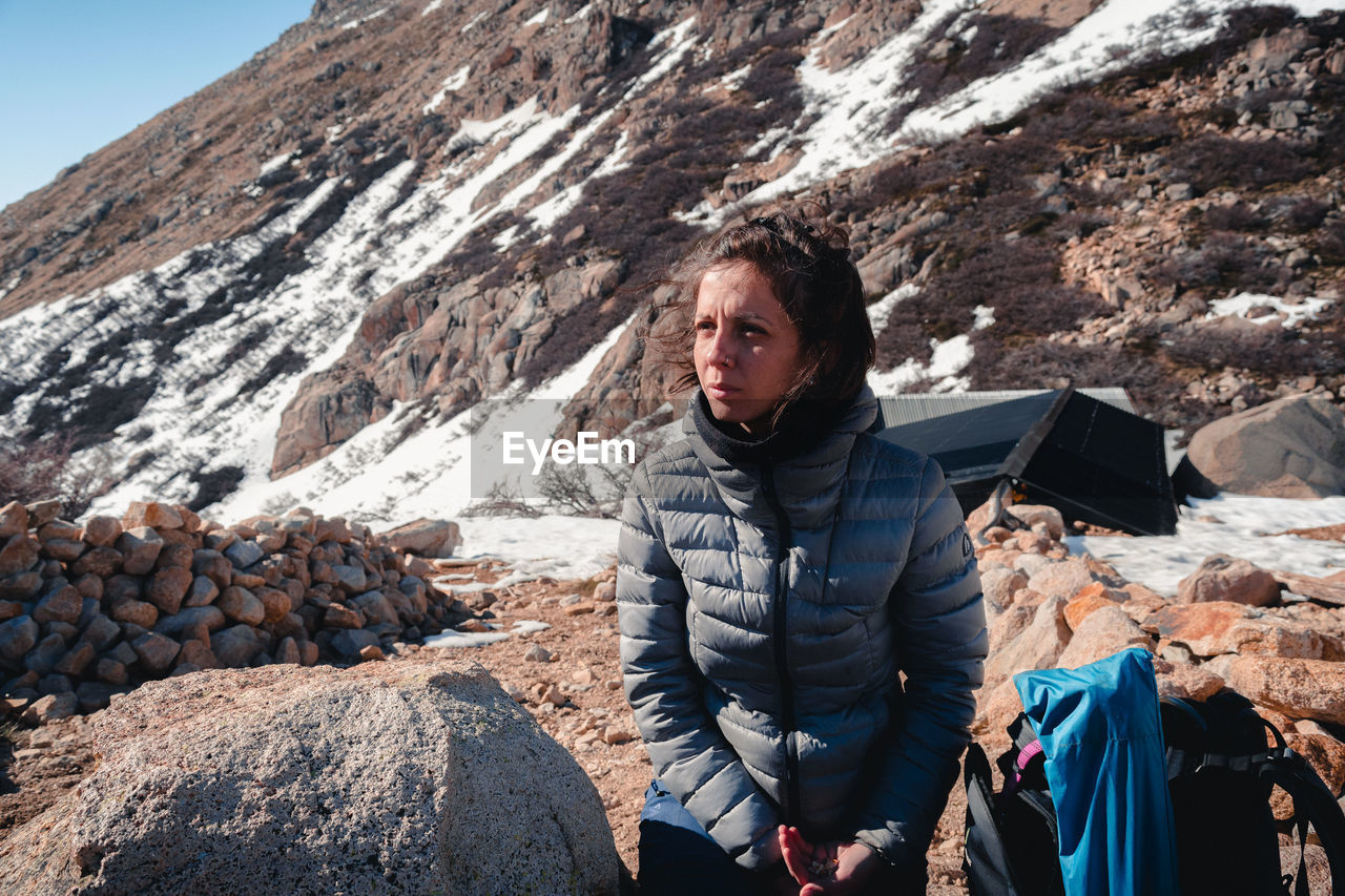 Woman looking away against landscape