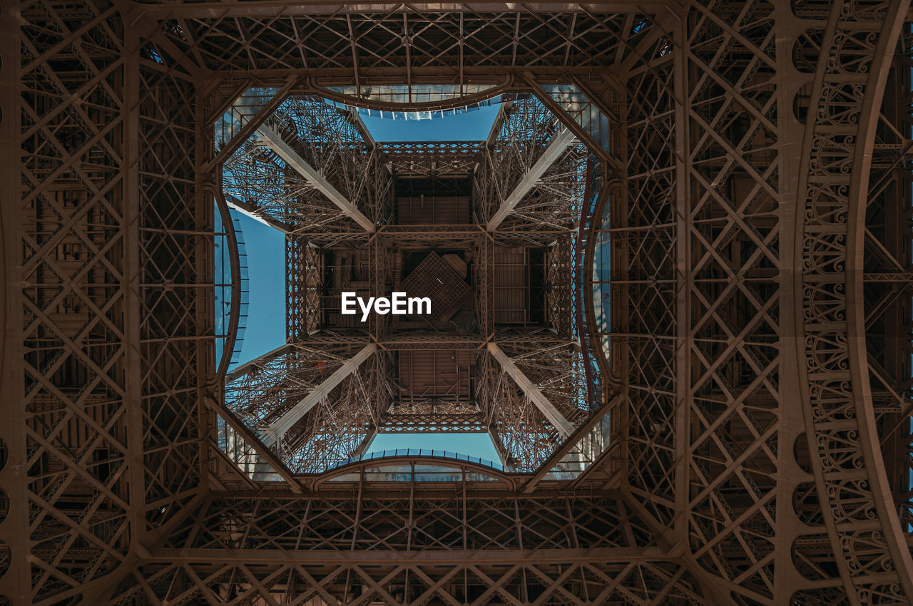 Bottom view of art nouveau style eiffel tower in paris. the famous capital of france.
