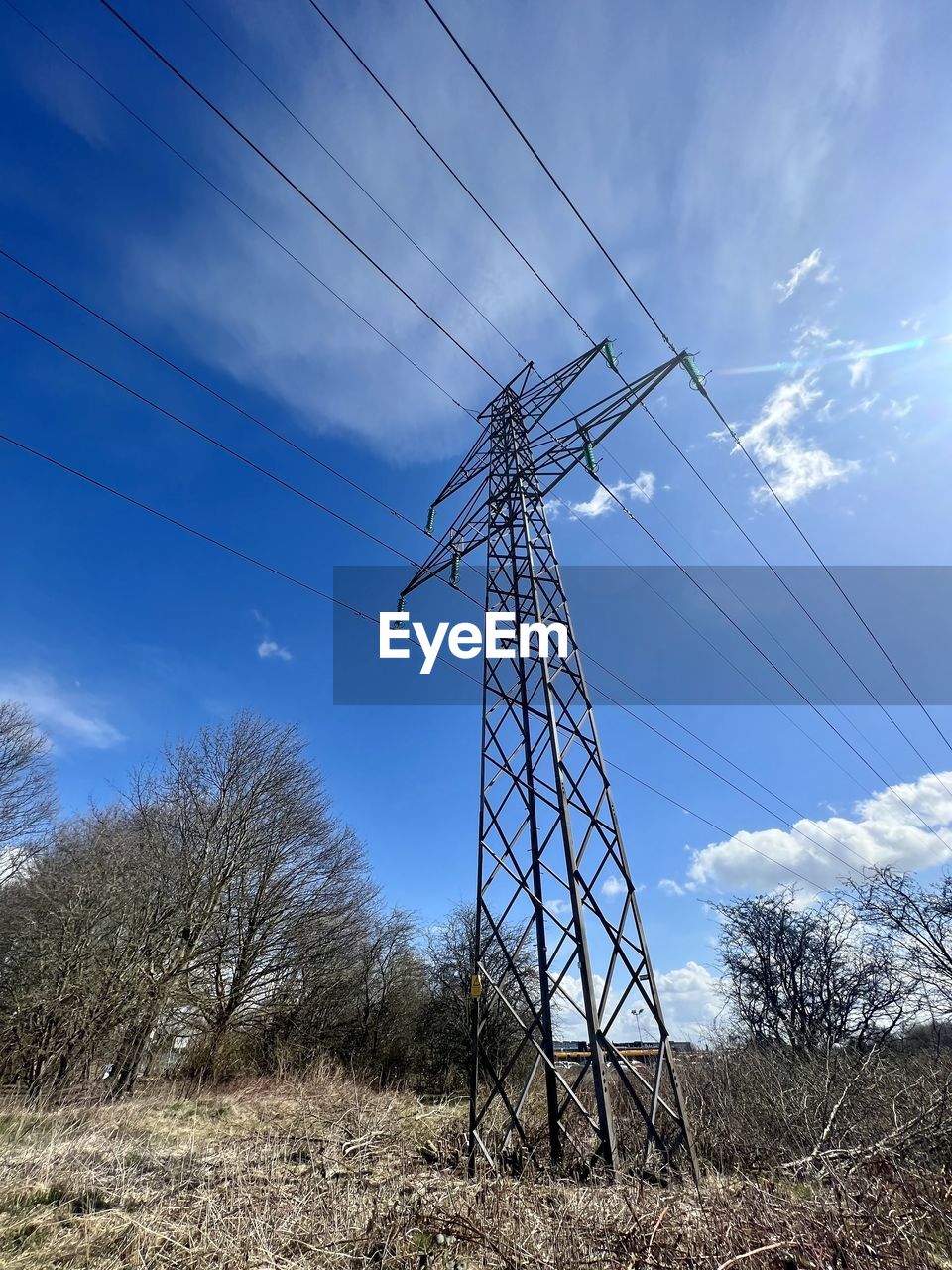 low angle view of electricity pylons against sky