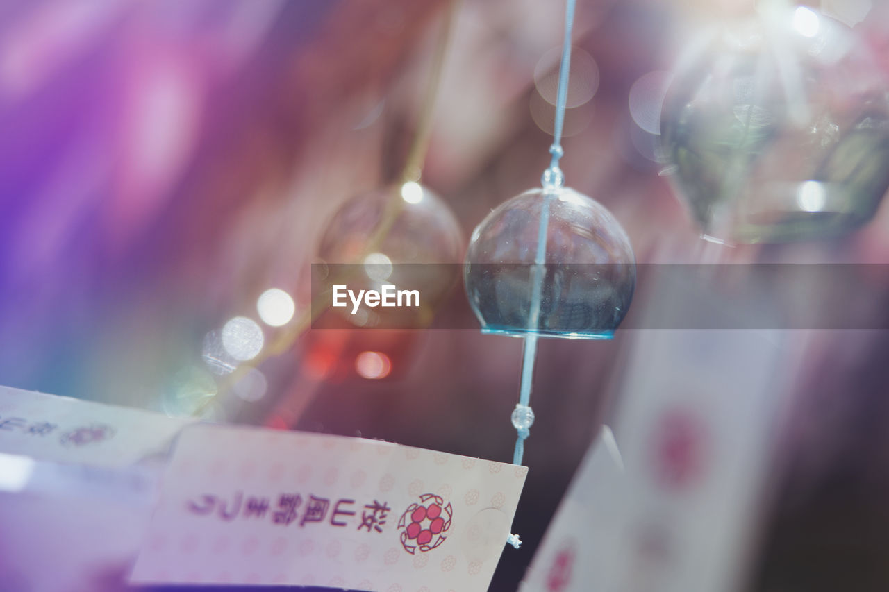 pink, selective focus, blue, close-up, red, purple, no people, indoors, hanging, lens flare, celebration