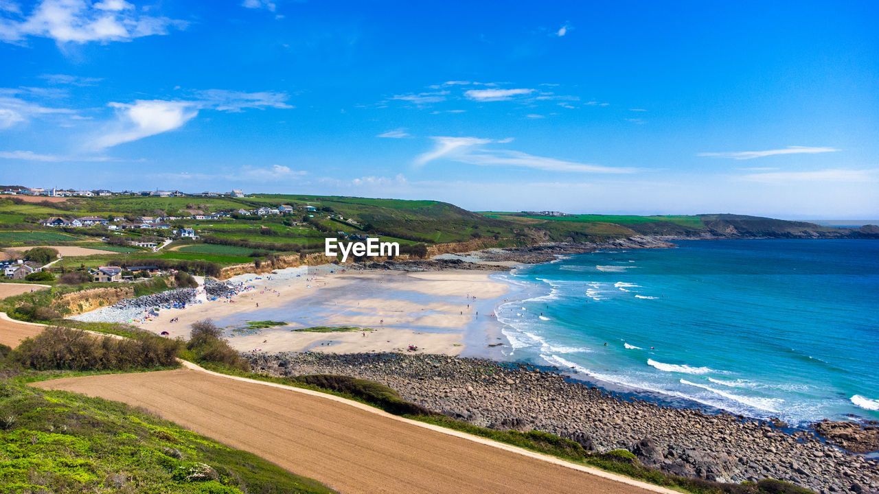 Scenic view of beach against blue sky