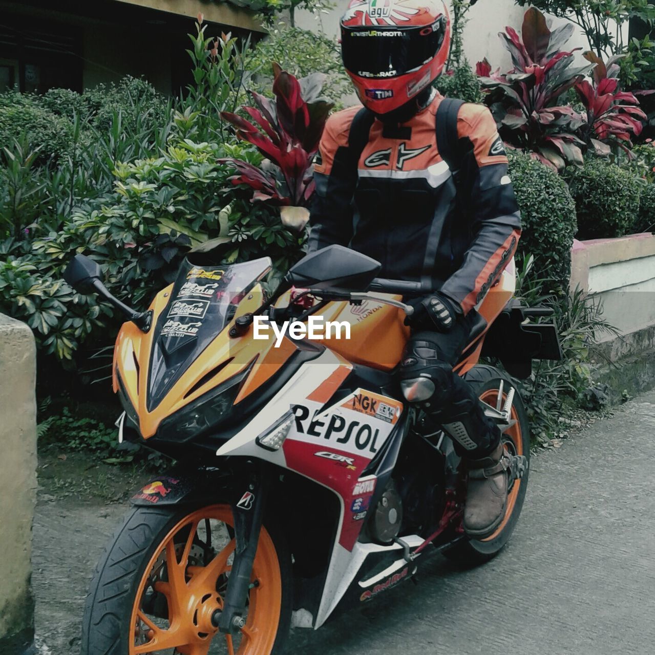 MAN WITH MOTORCYCLE AT BUS