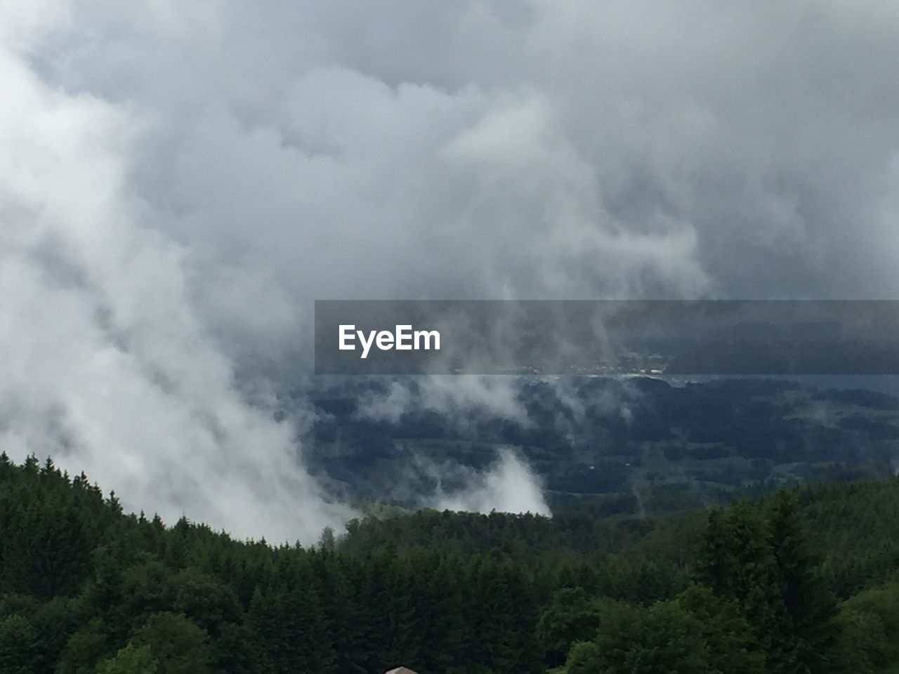 Scenic view of mountains against cloudy sky