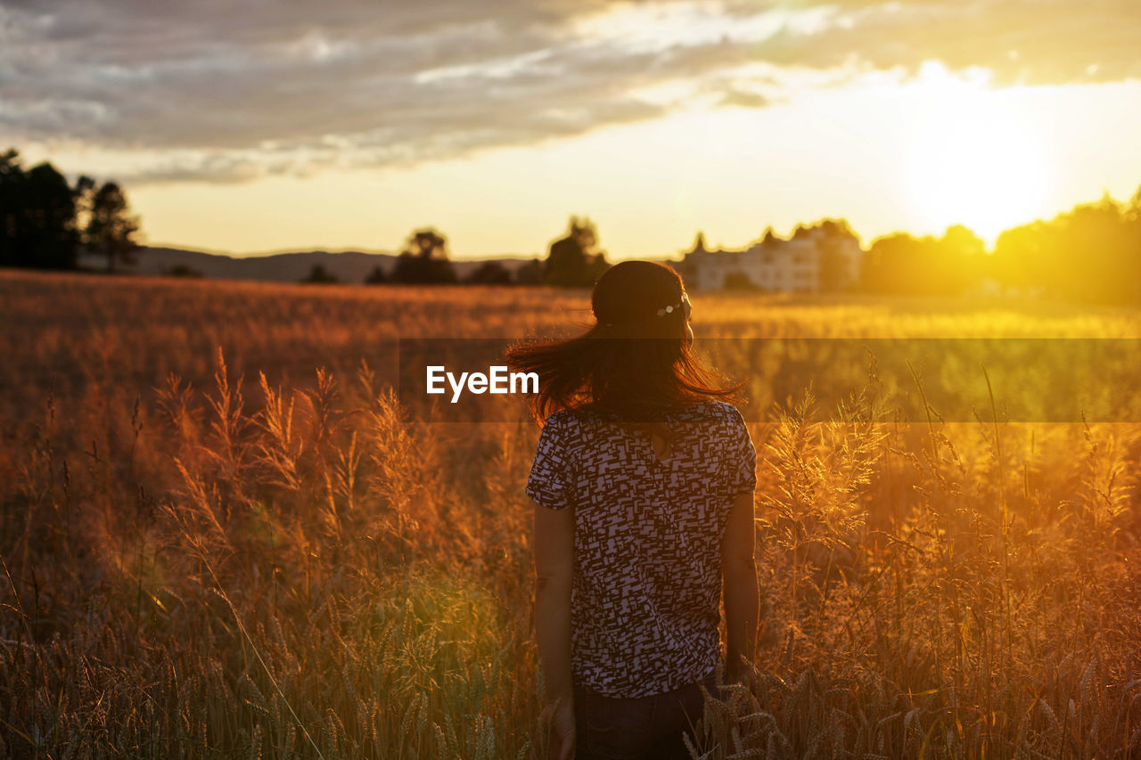 Rear view of woman looking at sunset