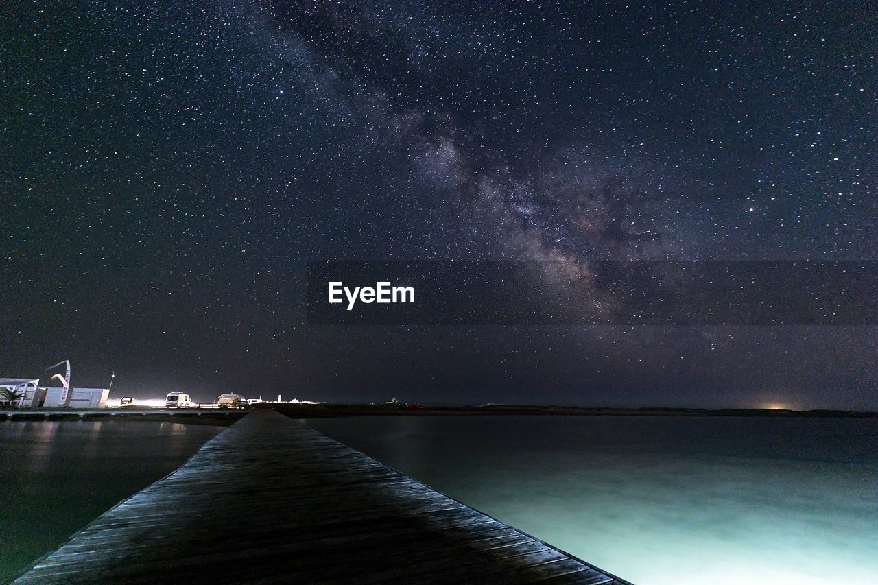 Scenic view of sea against sky at night with the milkyway