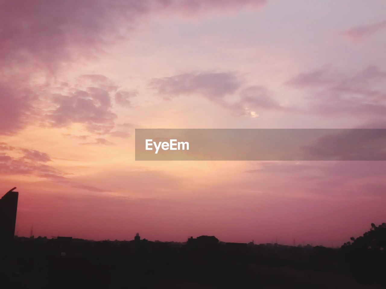 SCENIC VIEW OF SKY OVER SILHOUETTE TREES AGAINST SUNSET