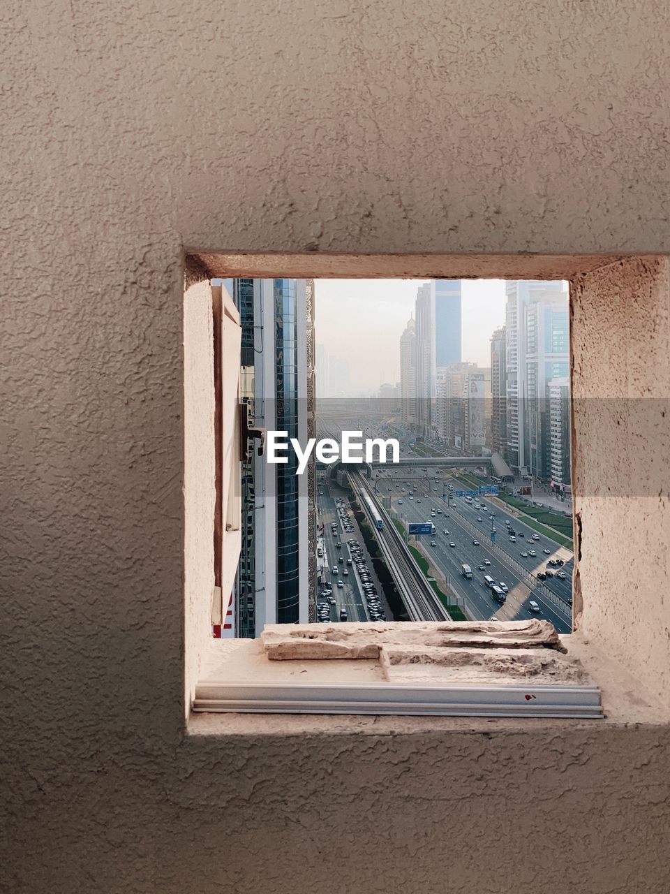 Buildings and city street seen through window