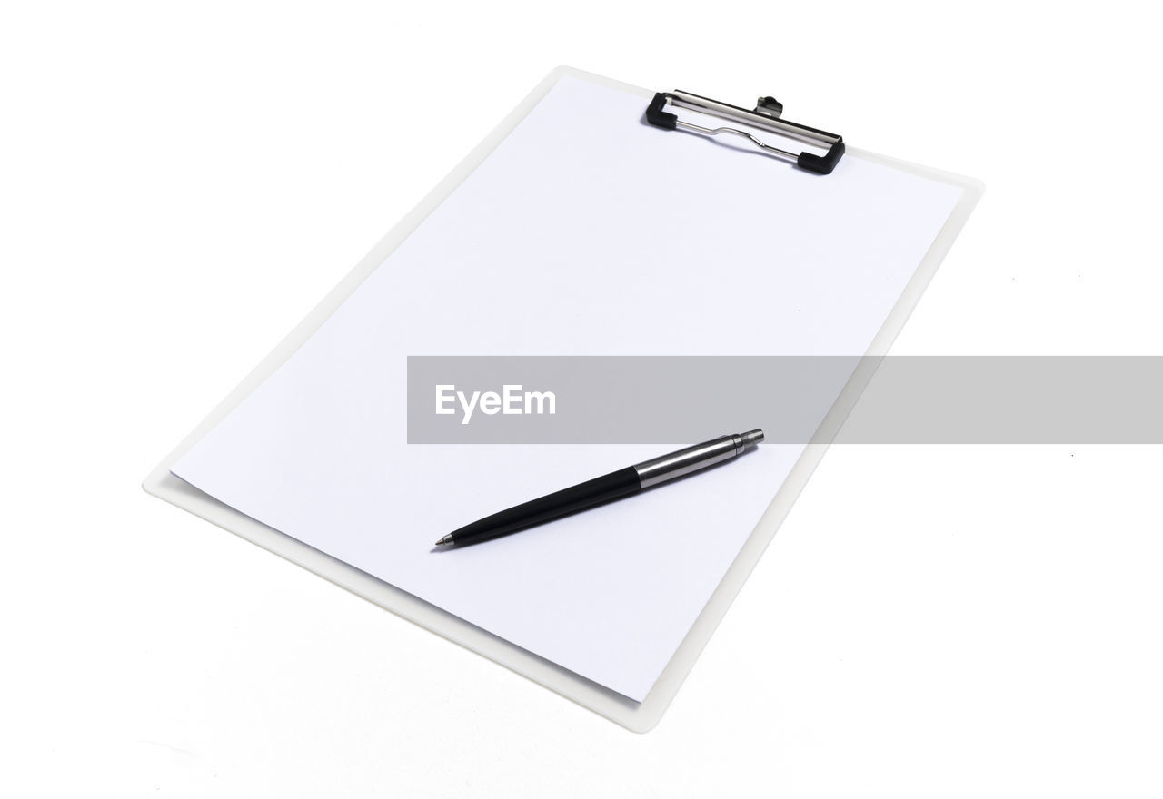 High angle view of pen and paper on white background