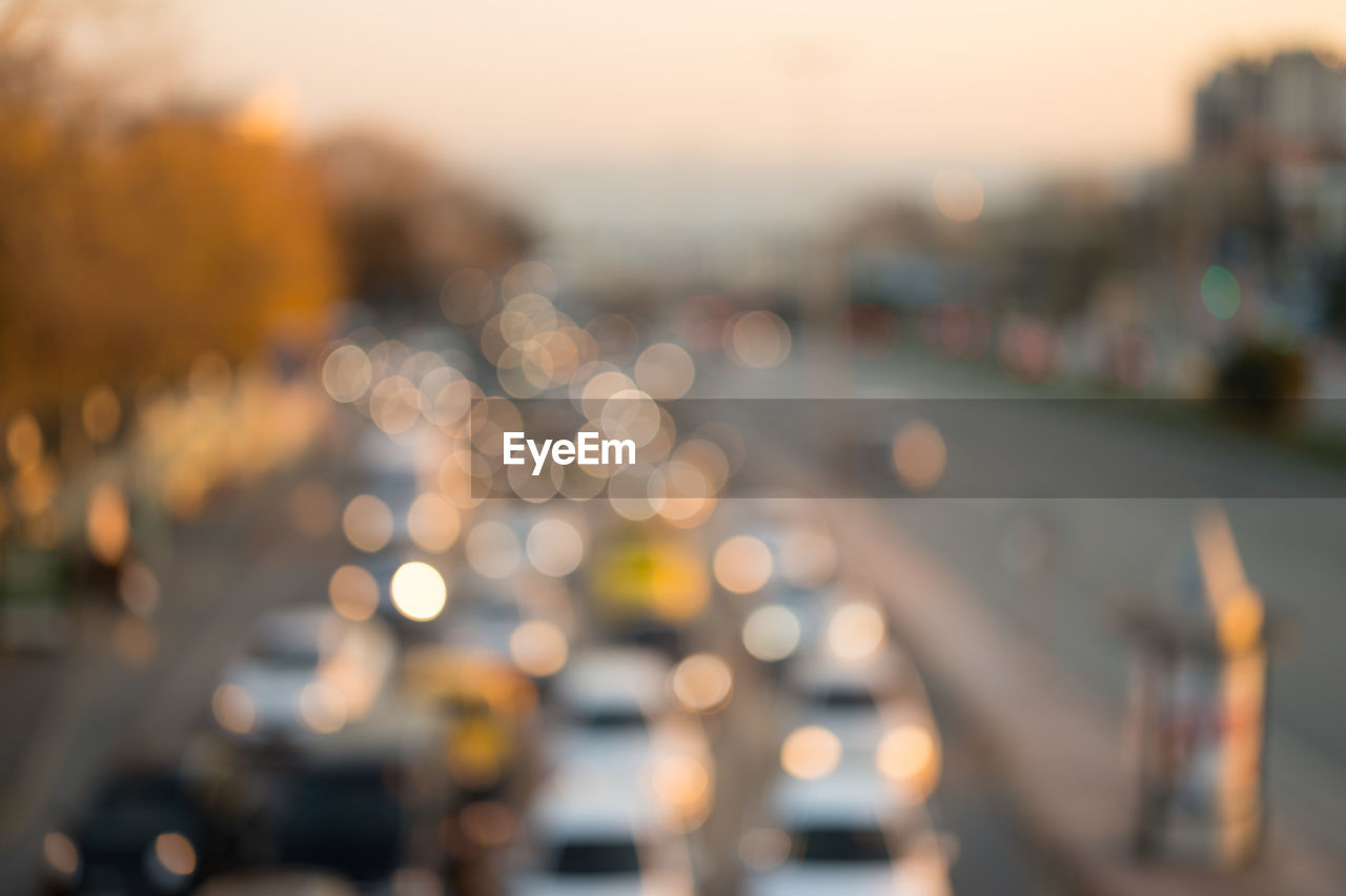 DEFOCUSED IMAGE OF ILLUMINATED CITYSCAPE