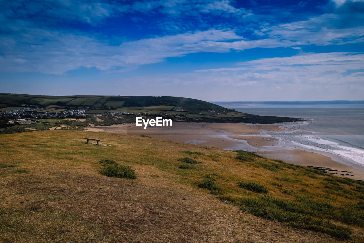 Scenic and colourful view of beach against dramatic blue sky