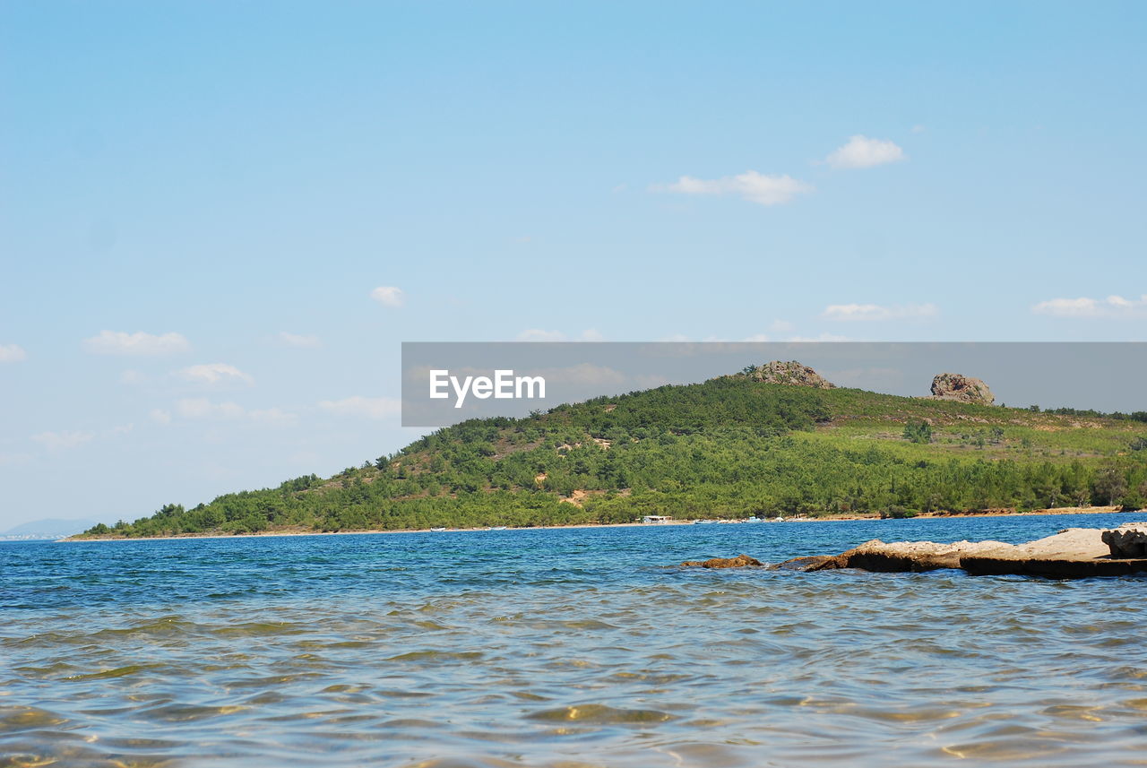 SCENIC VIEW OF SEA BY MOUNTAIN AGAINST SKY