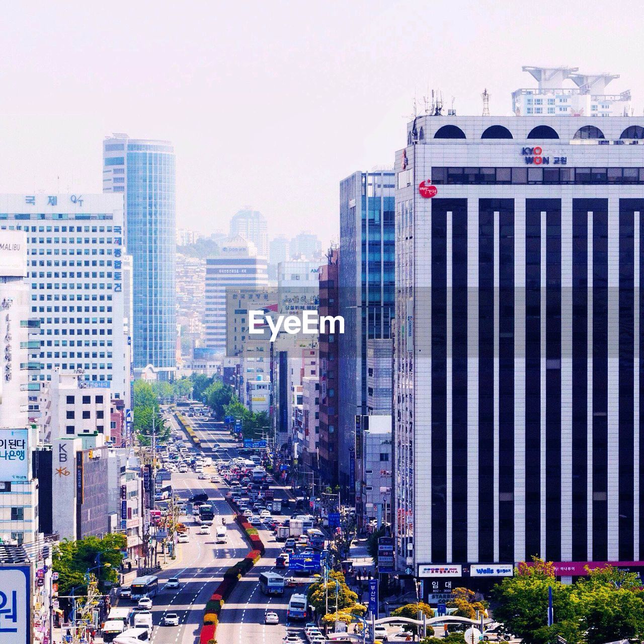 Buildings amidst city street against sky