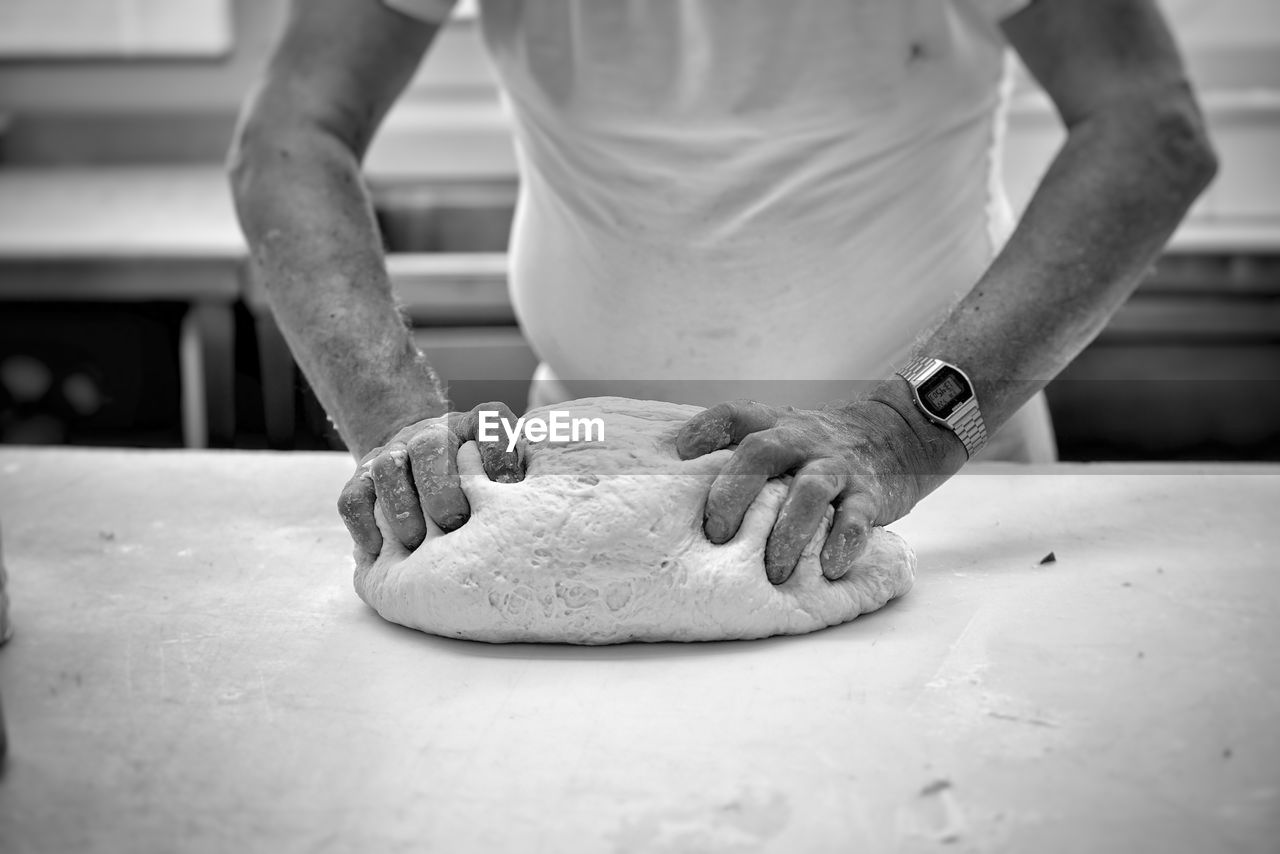 Close-up of man preparing food on cutting board