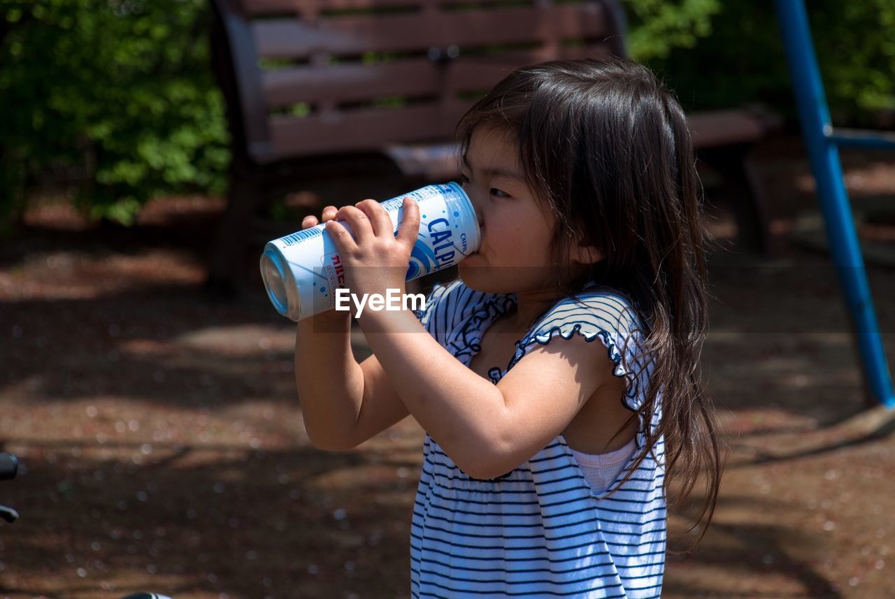 Girl drinking from can