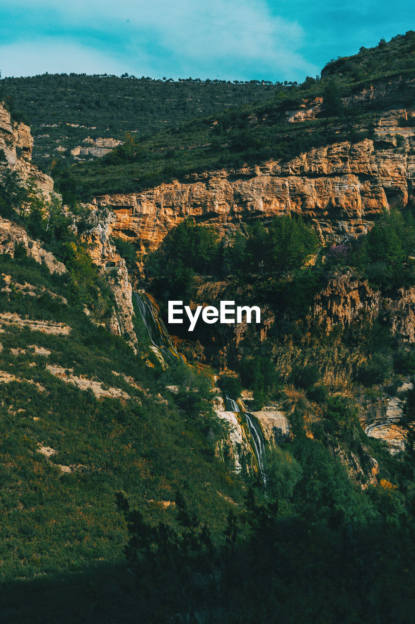 Scenic view of landscape and mountains against sky