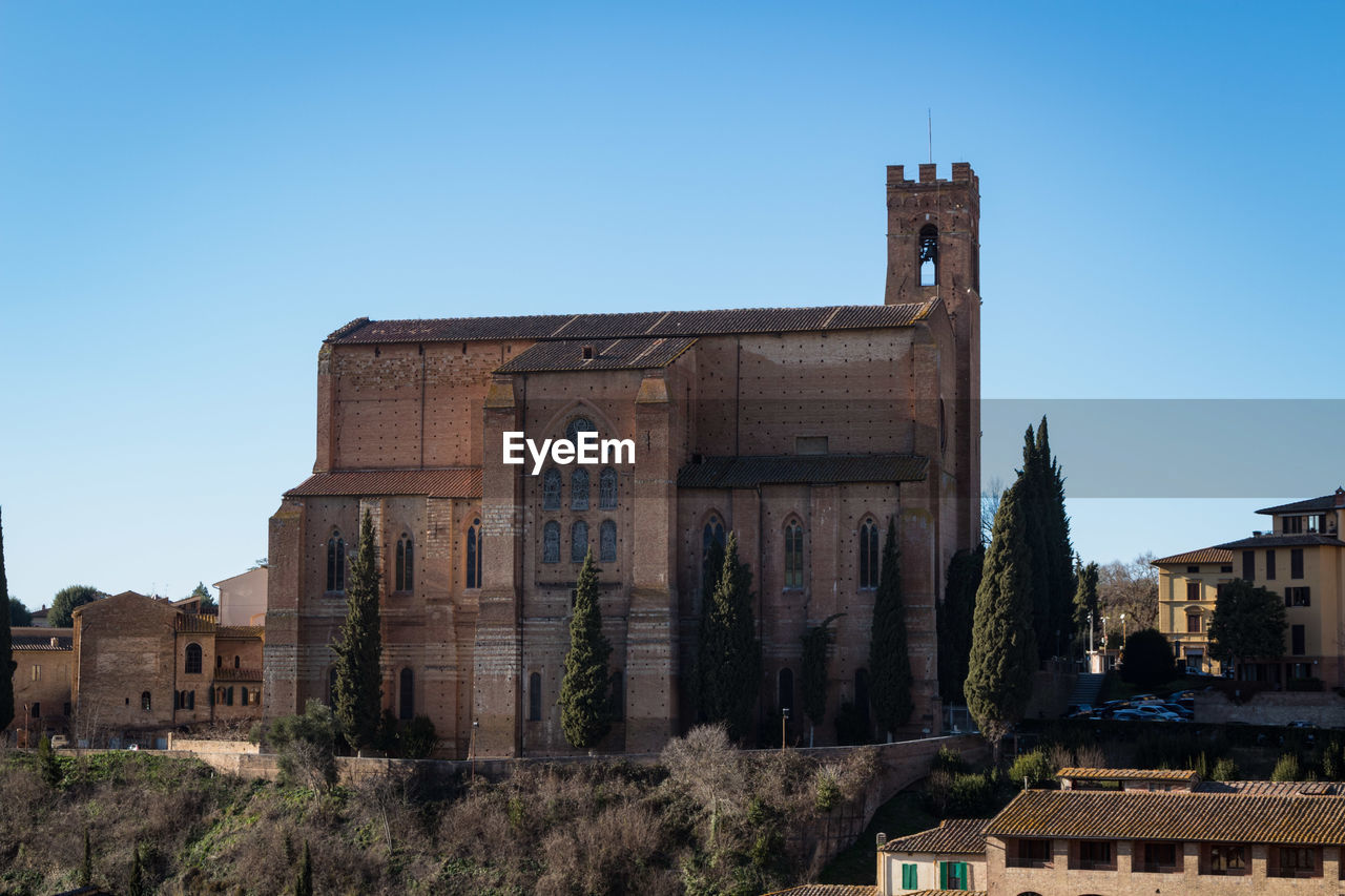 OLD BUILDINGS AGAINST CLEAR BLUE SKY