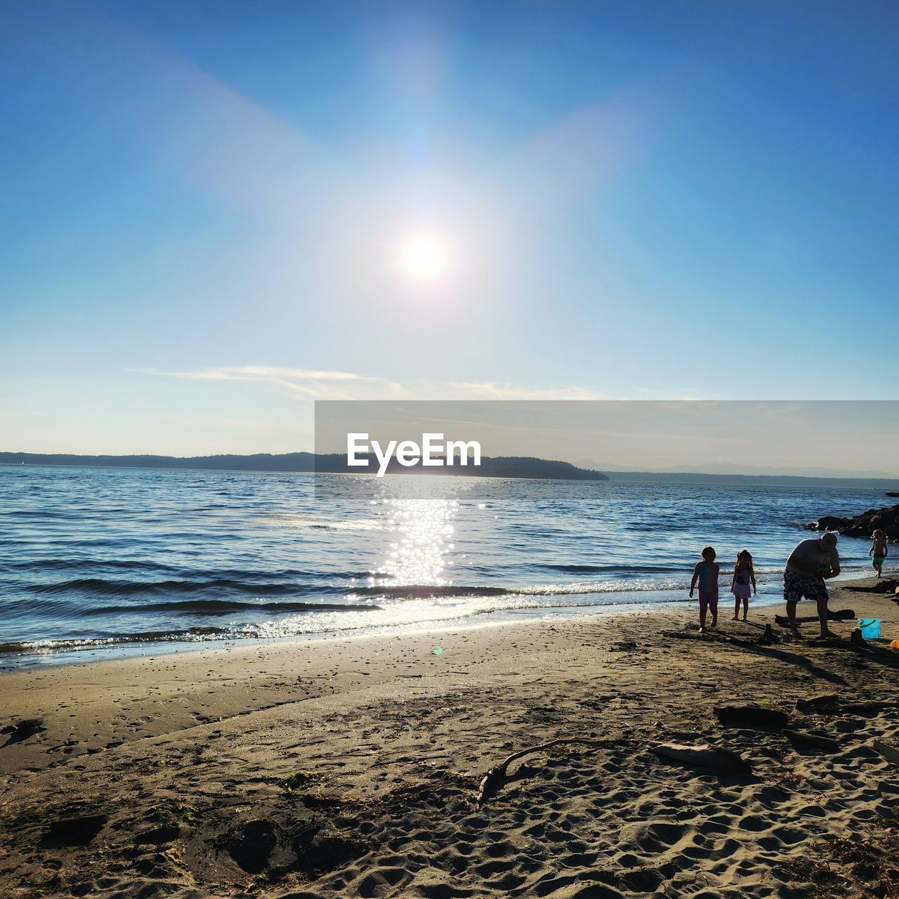 beach, sea, water, sky, land, horizon, body of water, ocean, shore, wave, sunlight, horizon over water, sand, nature, coast, beauty in nature, scenics - nature, group of people, wind wave, holiday, trip, cloud, vacation, leisure activity, sun, men, tranquility, adult, women, morning, dusk, togetherness, tranquil scene, motion, lifestyles, day, outdoors, travel destinations, bay, idyllic, shoal, summer, travel, clear sky, sunrise, walking, blue, child, sunny, relaxation, reflection