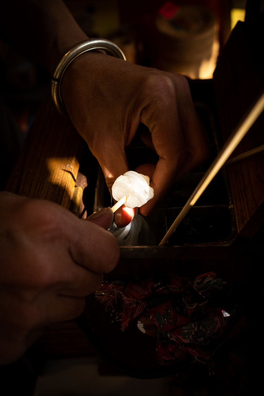 cropped hand of man playing chess at home