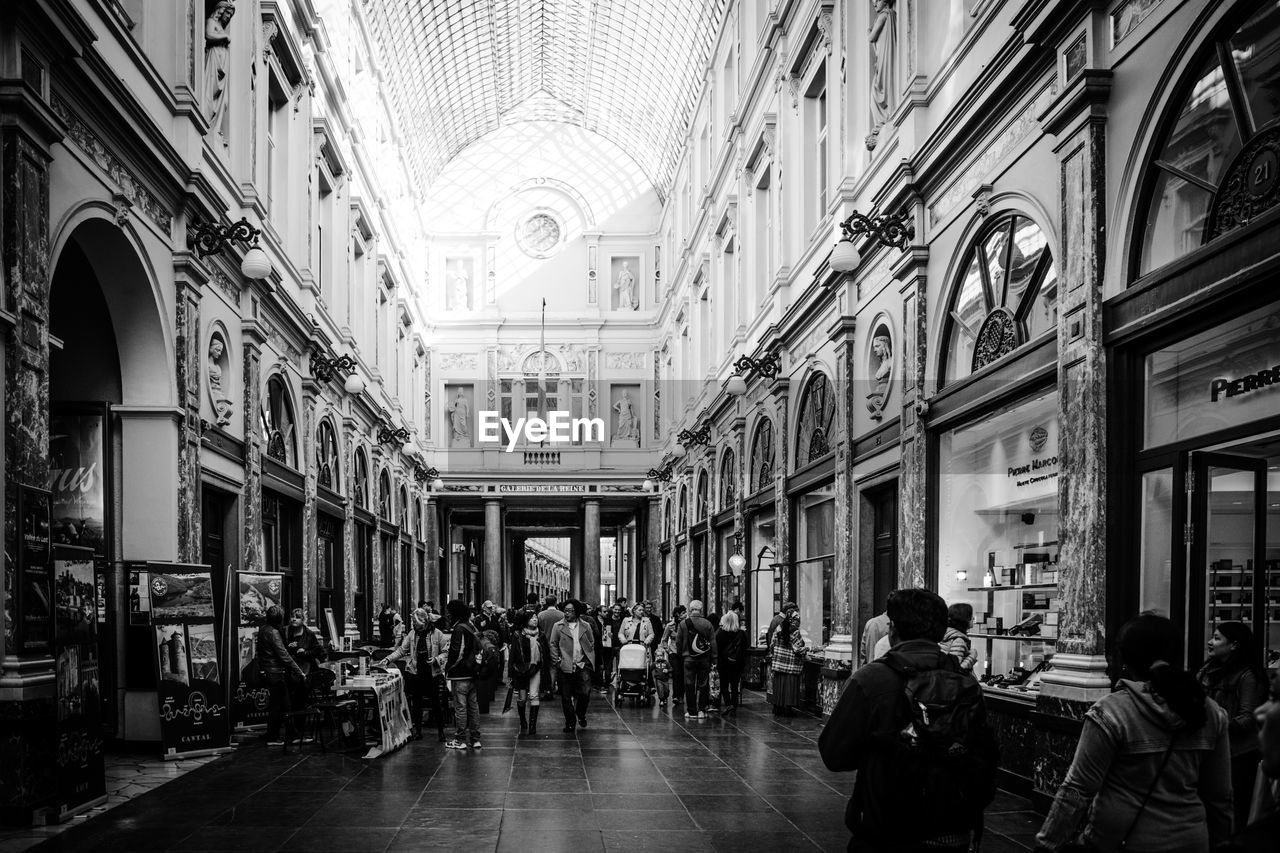 GROUP OF PEOPLE WALKING IN BUILDING