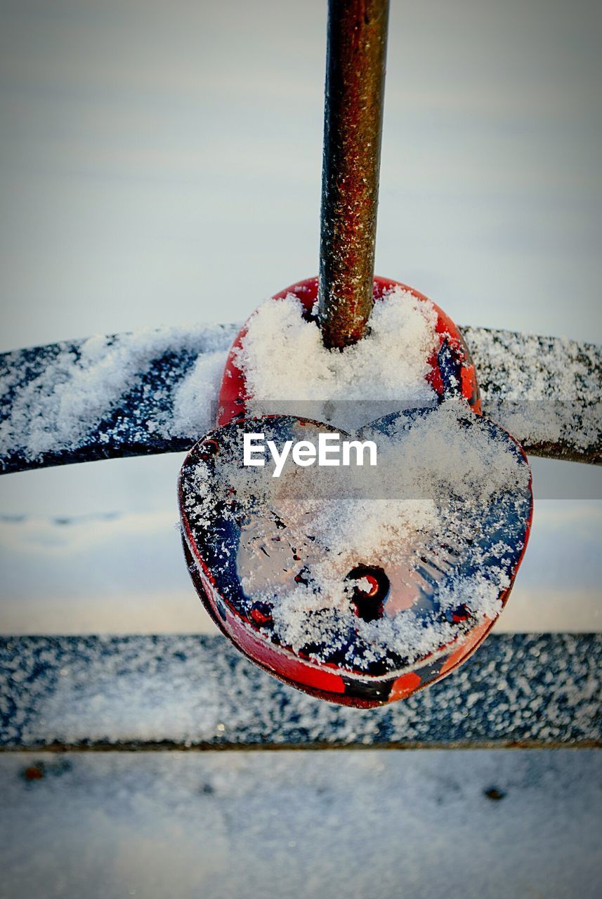 Close-up of snow on rusty metal during winter