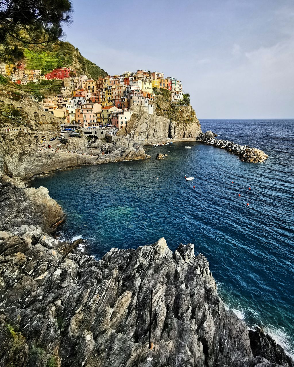 Scenic view of sea by townscape against sky