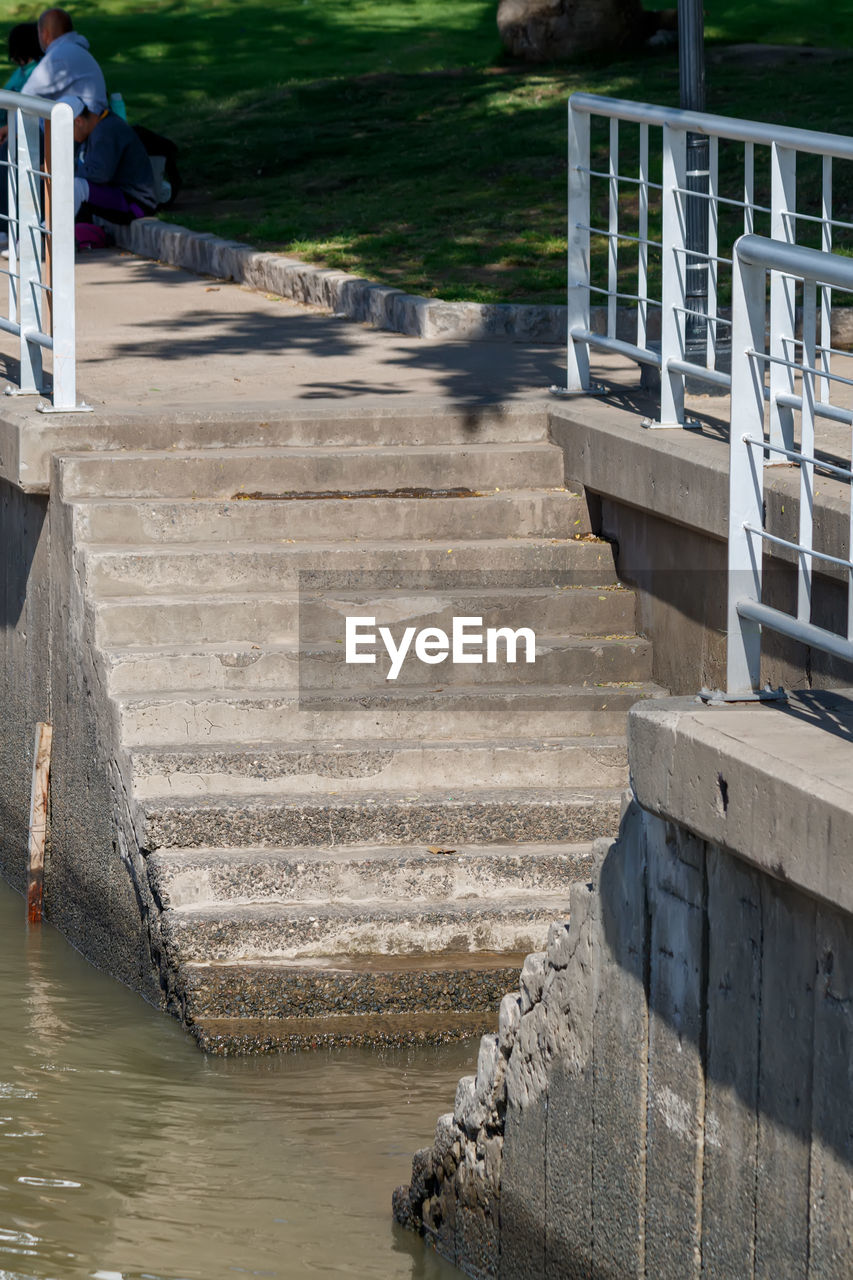 water, staircase, architecture, waterway, walkway, wall, nature, railing, steps and staircases, day, built structure, outdoors, high angle view, sunlight, men, river