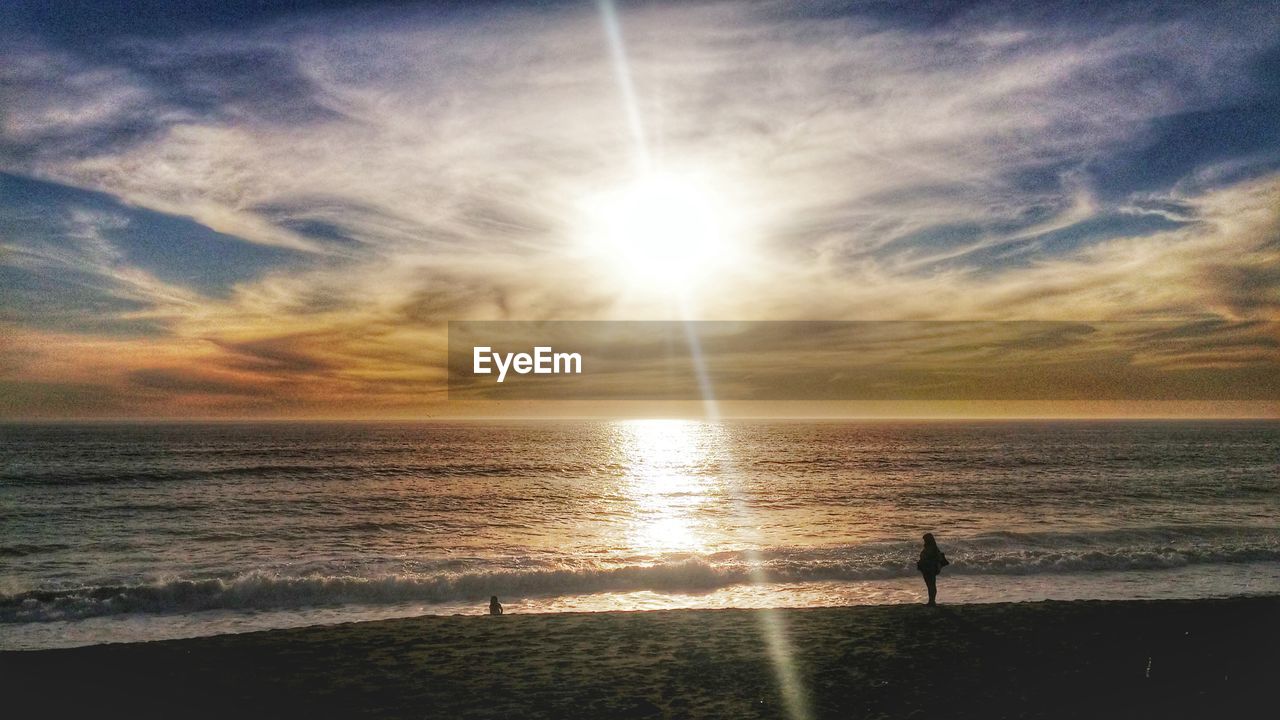 Scenic view of beach and sea against sky during sunset