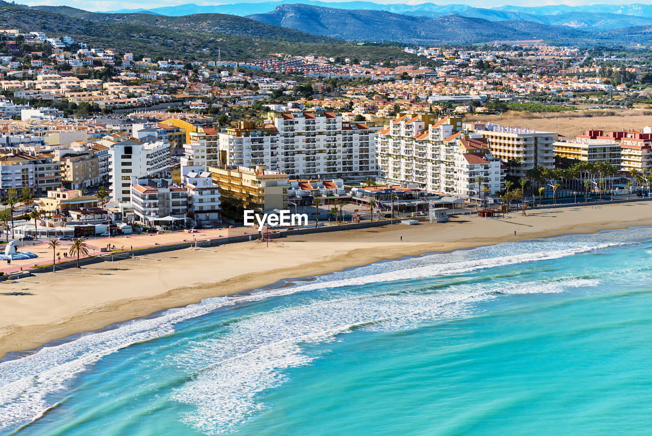 High angle view of buildings by sea during sunny day