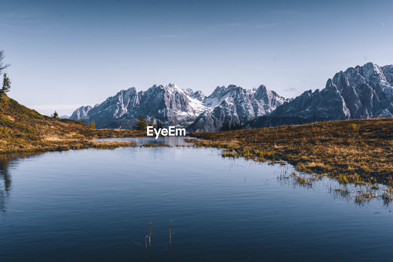 Scenic view of lake and mountains against sky