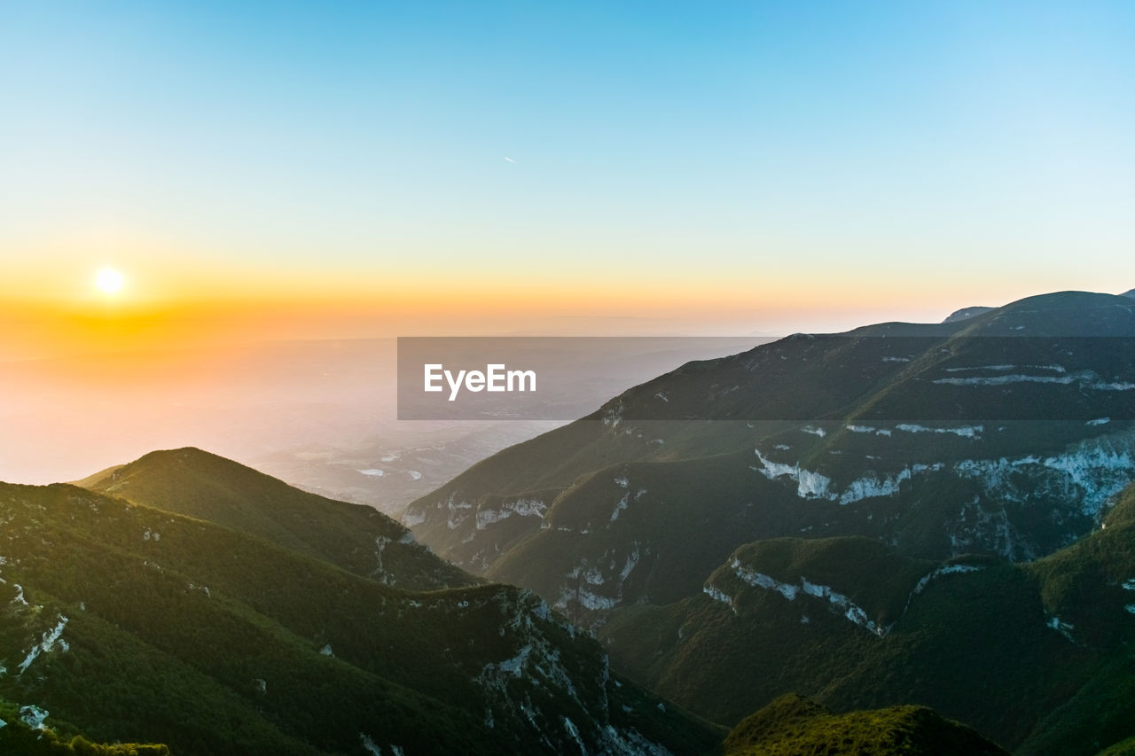 Scenic view of mountains against sky during sunset