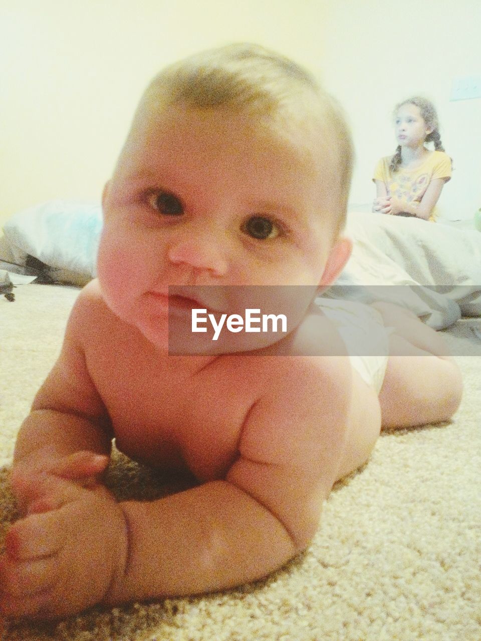 Portrait of cute baby boy lying on rug