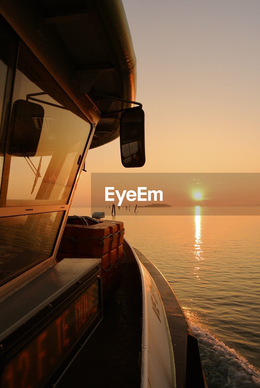 Scenic view of sea seen through boat during sunset