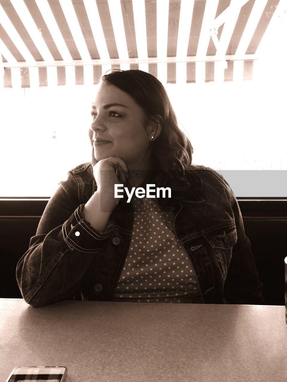 Thoughtful woman sitting on chair at restaurant