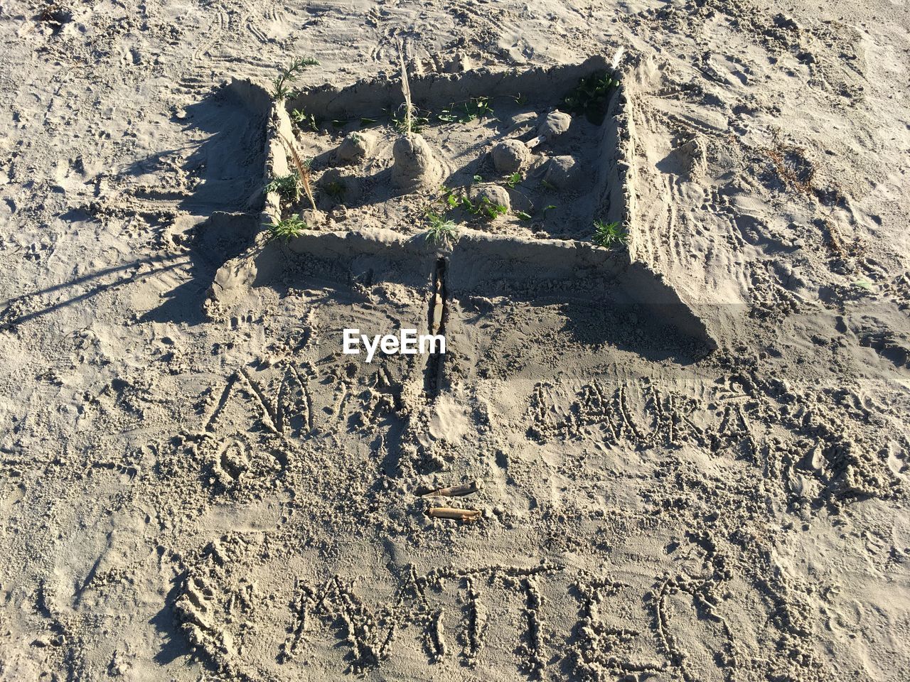 HIGH ANGLE VIEW OF SHADOW ON SAND ON GROUND
