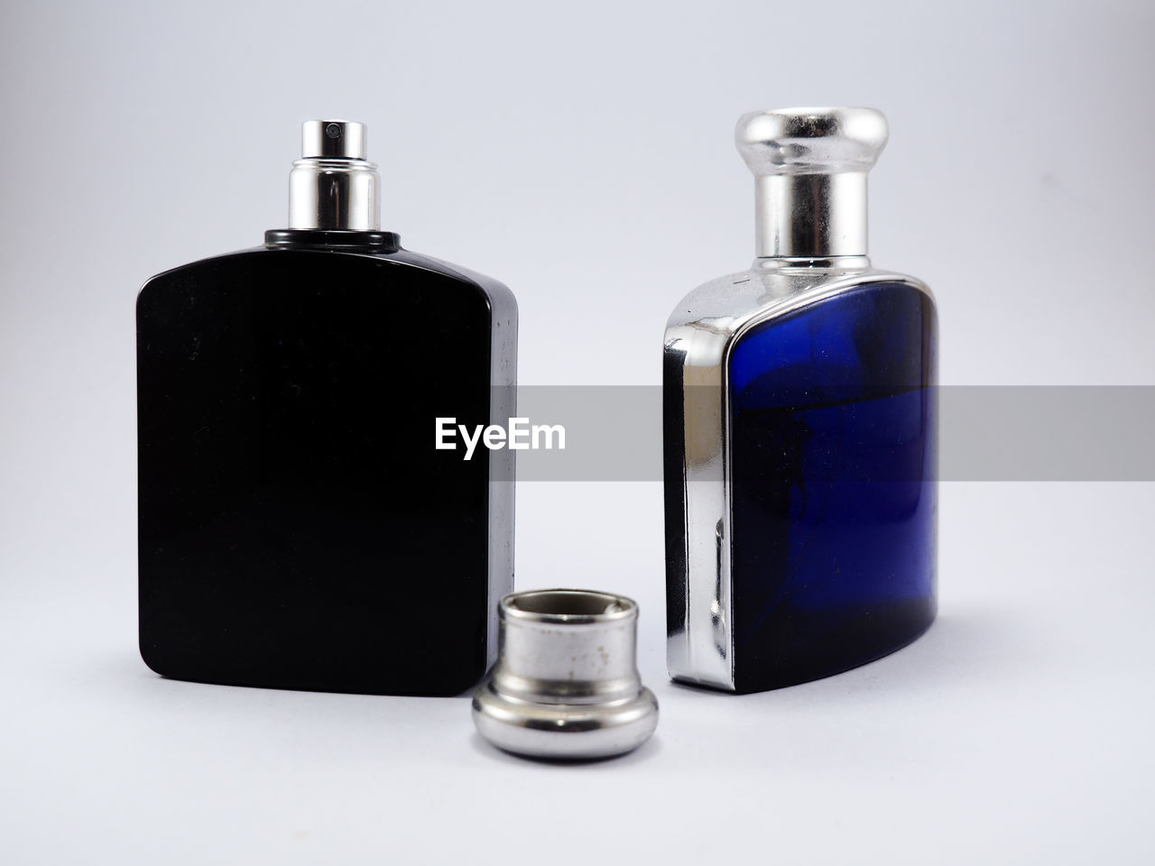 Close-up of perfume bottle against white background