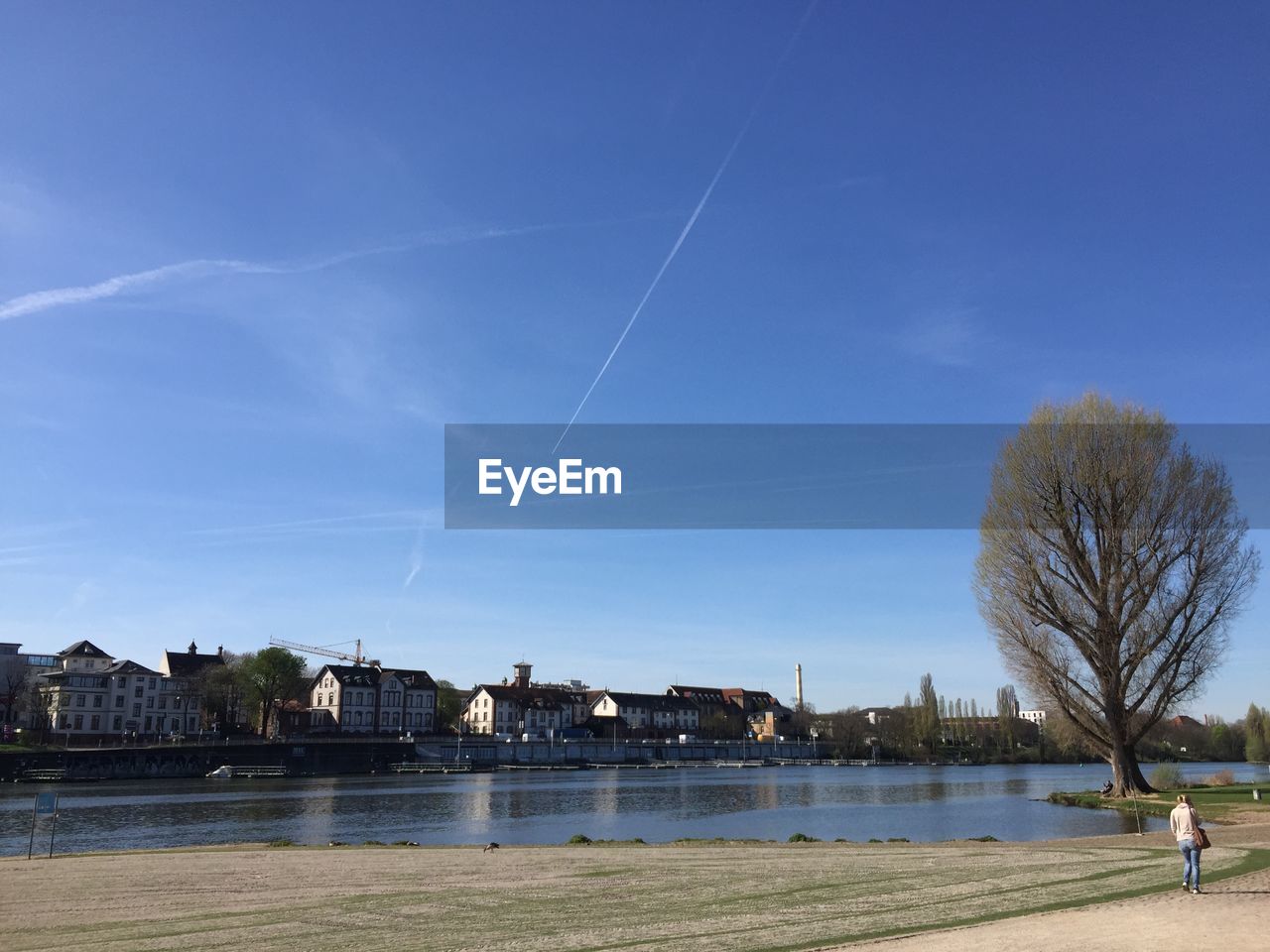 SCENIC VIEW OF LAKE BY BUILDING AGAINST BLUE SKY